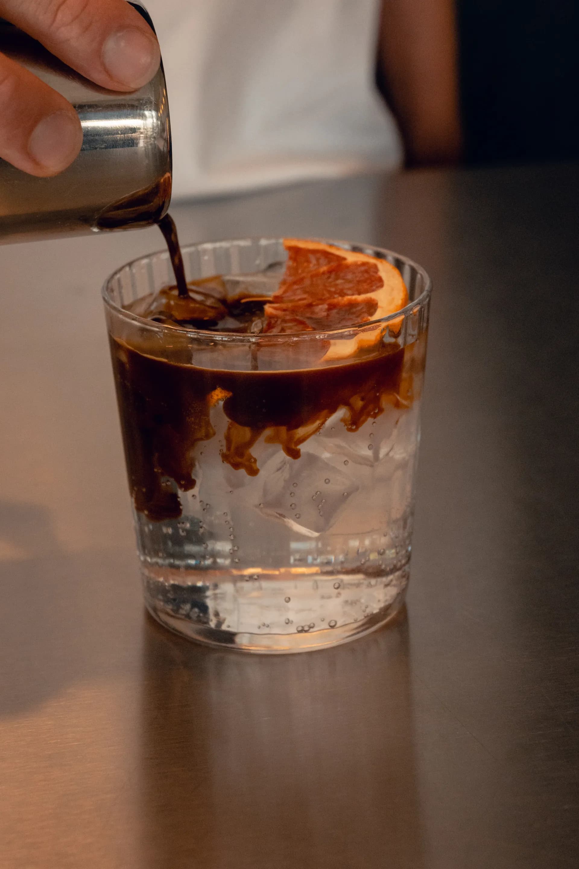 Espresso poured over ice and orange